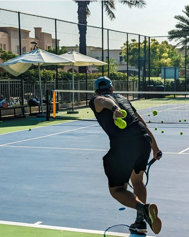Davide Spadoni on court with tennis balls