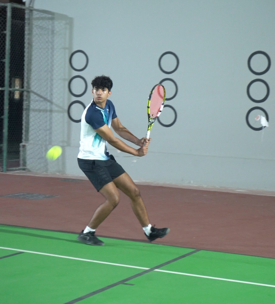 Young boy practicing a forehand stroke